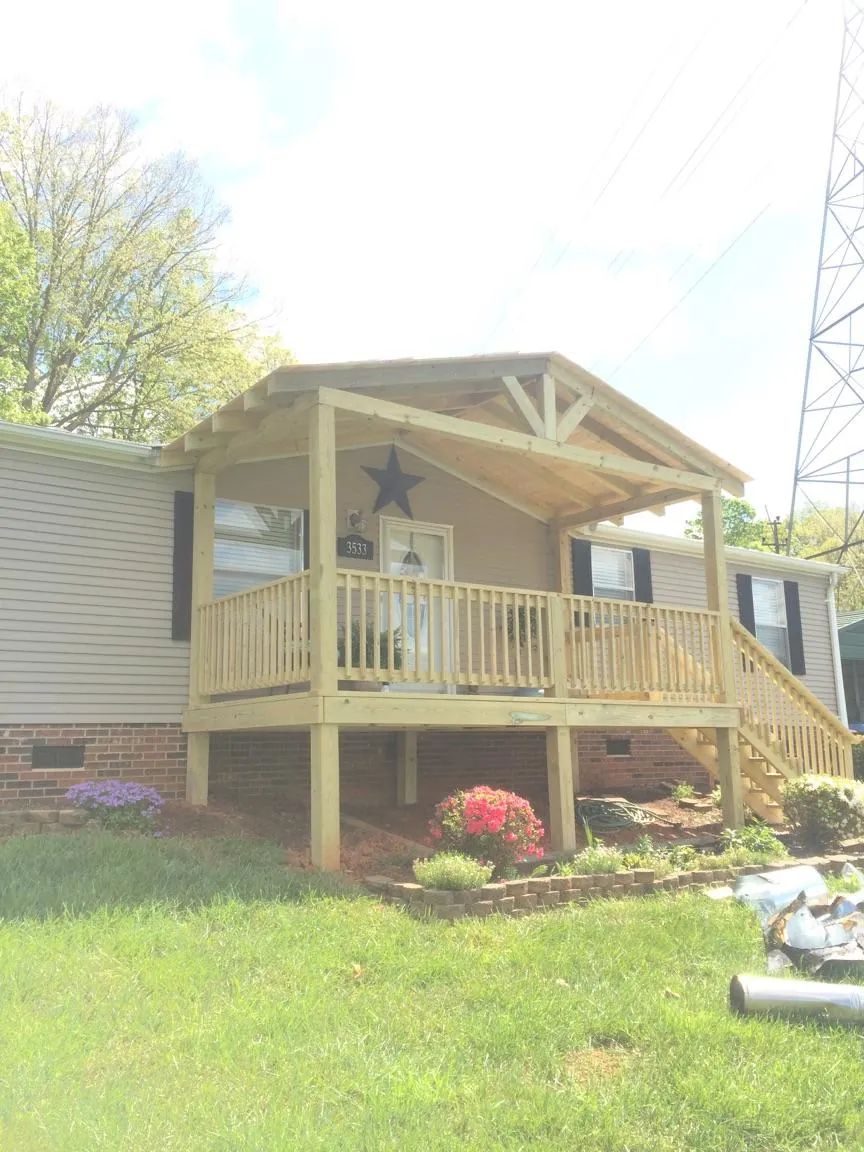 New gabled porch roof and deck railing added to a ranch home in Burkeville